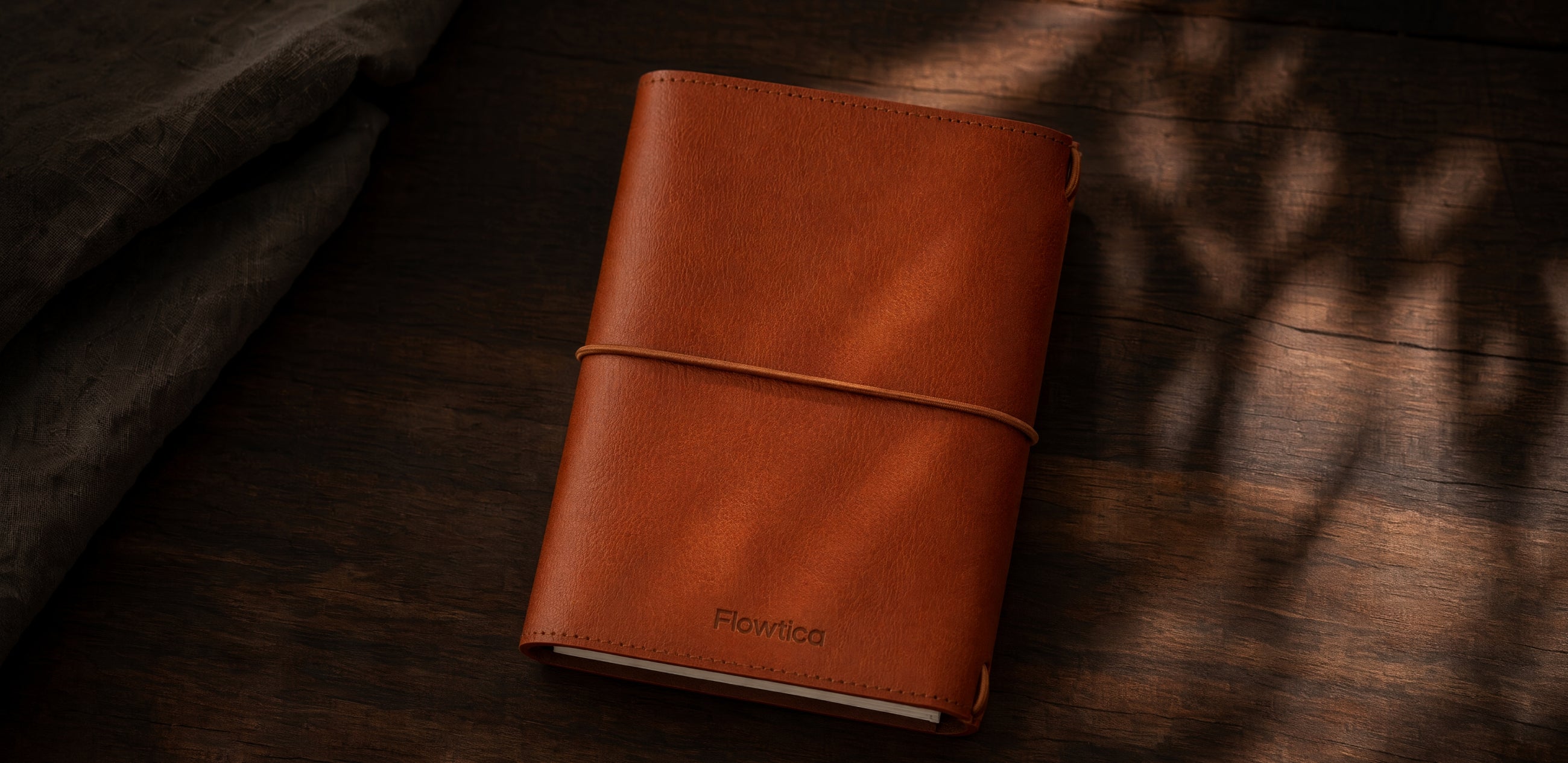 Flowtica Scribe pen and leather case on a stone desk