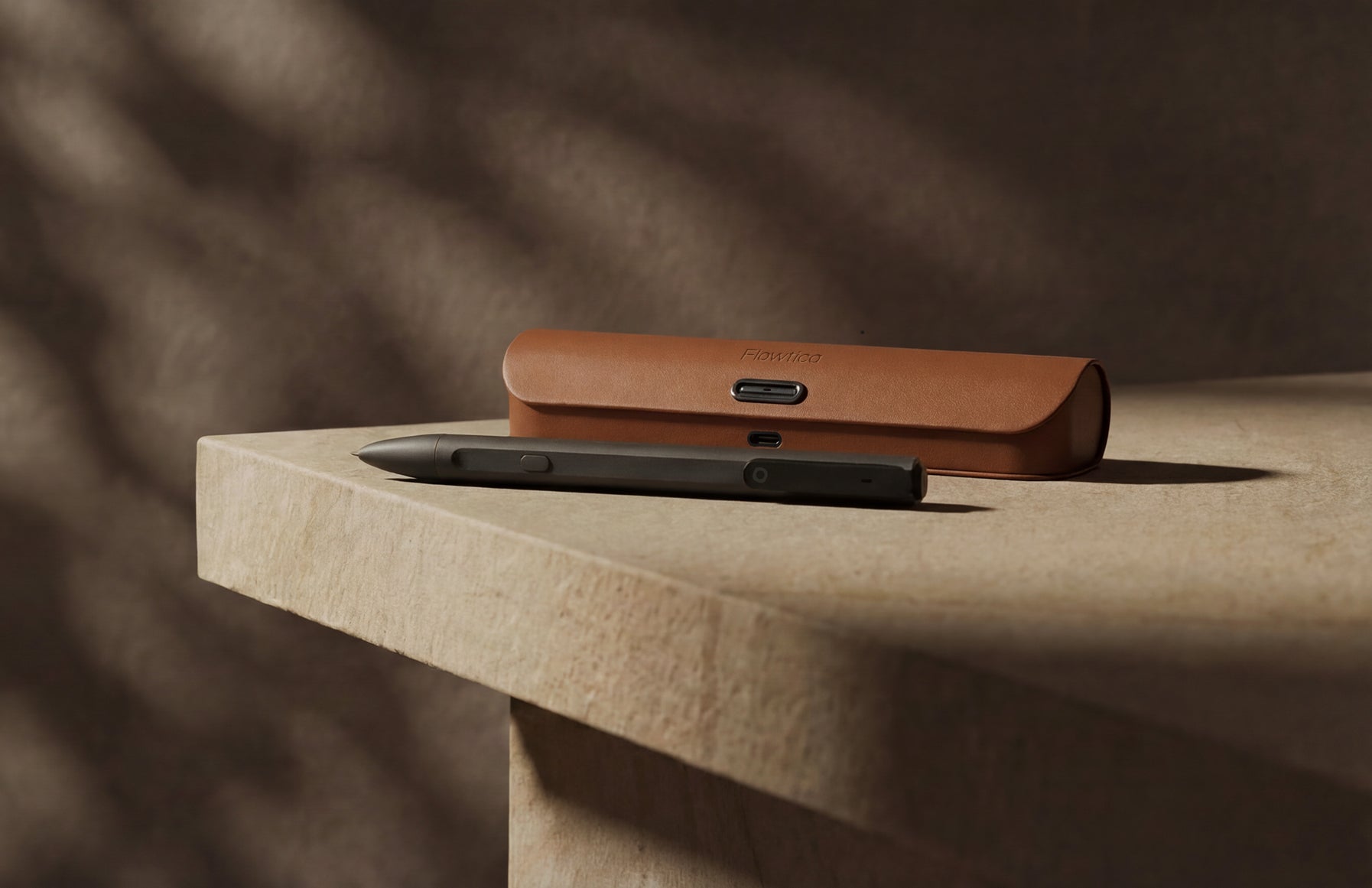 Flowtica Scribe pen and leather case on a stone desk